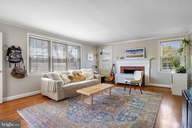 living area featuring wood finished floors, a healthy amount of sunlight, and crown molding
