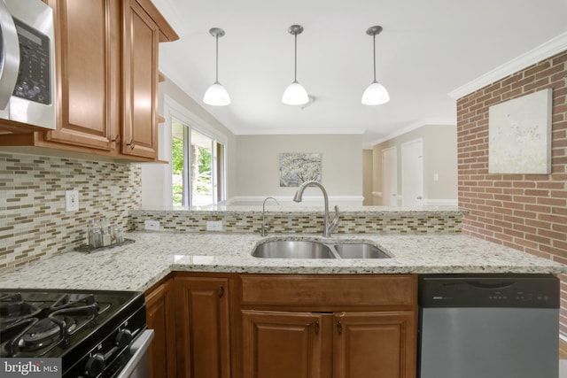 kitchen with appliances with stainless steel finishes, a sink, decorative backsplash, ornamental molding, and brown cabinets