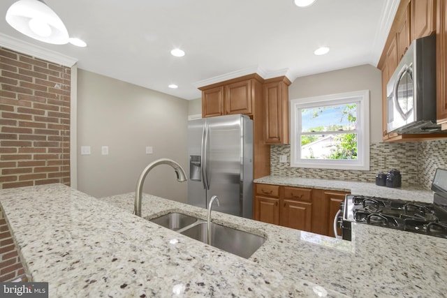 kitchen with stainless steel appliances, a sink, decorative backsplash, light stone countertops, and recessed lighting