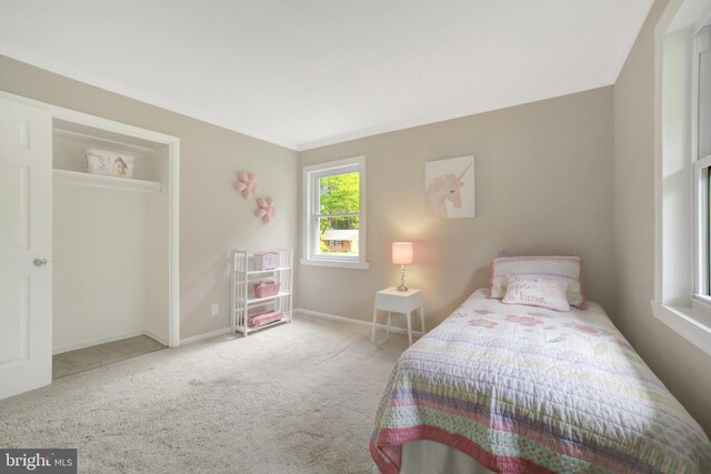 carpeted bedroom featuring crown molding and baseboards
