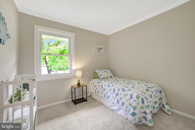 carpeted bedroom featuring baseboards and ornamental molding