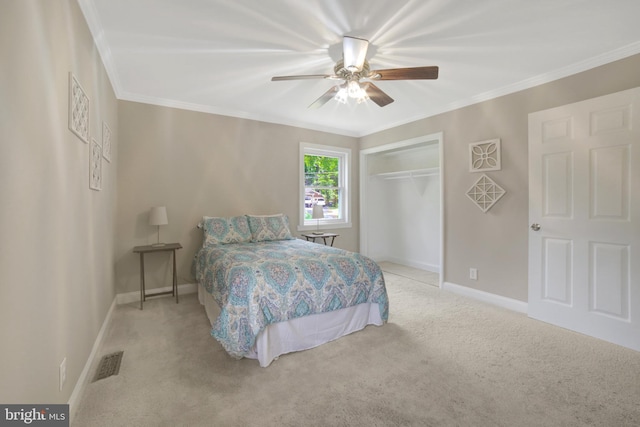 carpeted bedroom with baseboards, a closet, crown molding, and ceiling fan