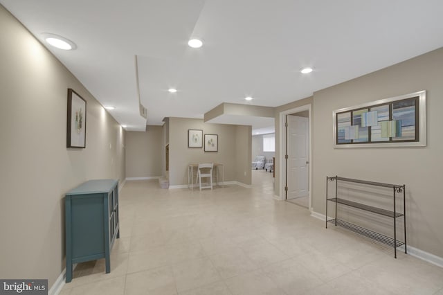 finished below grade area featuring baseboards and recessed lighting