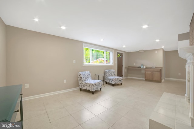 sitting room featuring light tile patterned flooring, baseboards, and recessed lighting