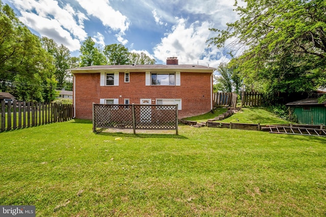 rear view of property with a chimney and brick siding