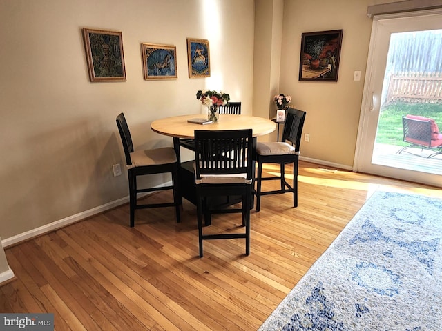dining room with baseboards and light wood-style floors