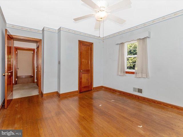 268 Magothy Bridge Rd, Pasadena, MD 21122 - unfurnished bedroom with baseboards, ceiling fan, hardwood / wood-style flooring, and visible vents
