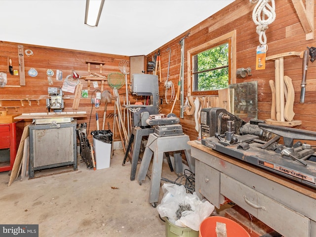 268 Magothy Bridge Rd, Pasadena, MD 21122 - miscellaneous room featuring wooden walls, a workshop area, and unfinished concrete flooring