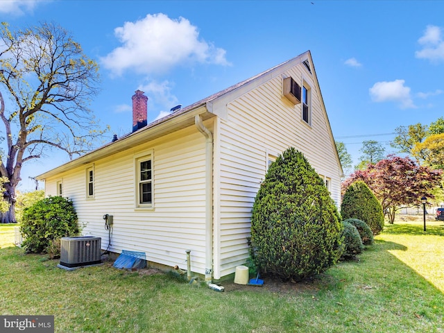 268 Magothy Bridge Rd, Pasadena, MD 21122 - view of property exterior with central AC unit, a chimney, and a yard