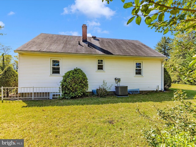 268 Magothy Bridge Rd, Pasadena, MD 21122 - rear view of property with a yard, a chimney, central AC unit, and roof with shingles