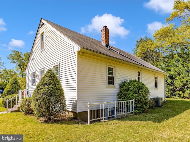 268 Magothy Bridge Rd, Pasadena, MD 21122 - view of home's exterior featuring a lawn, central AC unit, and a chimney