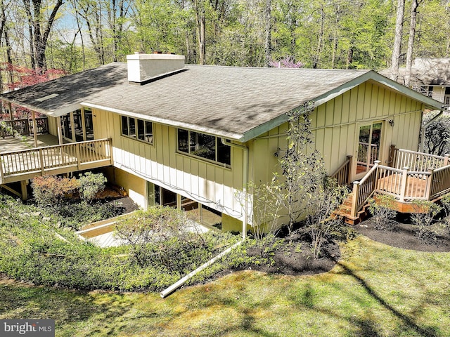 694 Trowill Ln, Wayne, PA 19087 - view of side of property with a shingled roof, a deck, and a chimney