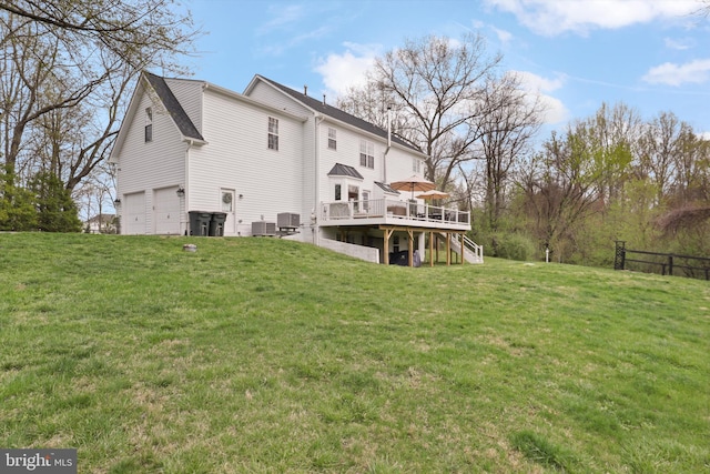 rear view of property with a wooden deck, stairs, an attached garage, and central AC unit