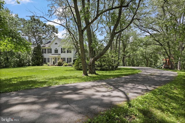 view of front of home featuring a front yard and a playground