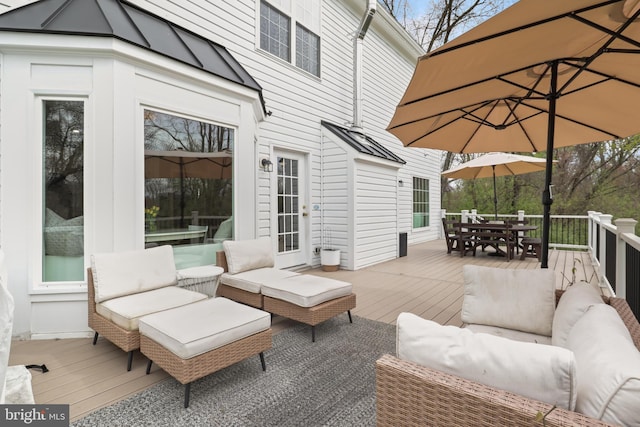 deck with an outdoor living space and outdoor dining area