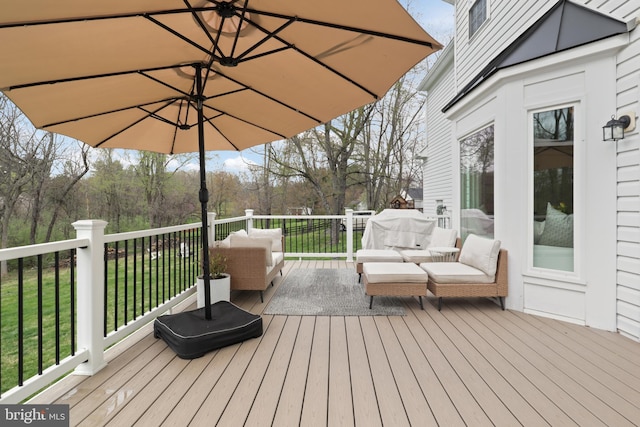 wooden terrace featuring a lawn