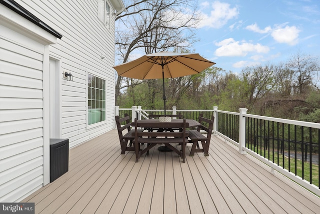 wooden terrace with outdoor dining area