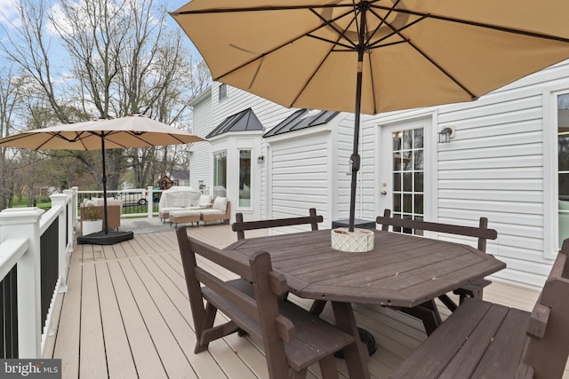 wooden terrace with outdoor dining area and outdoor lounge area