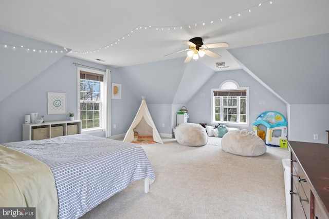 carpeted bedroom featuring multiple windows, lofted ceiling, and baseboards
