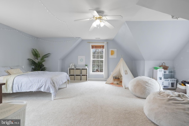 carpeted bedroom featuring vaulted ceiling and a ceiling fan
