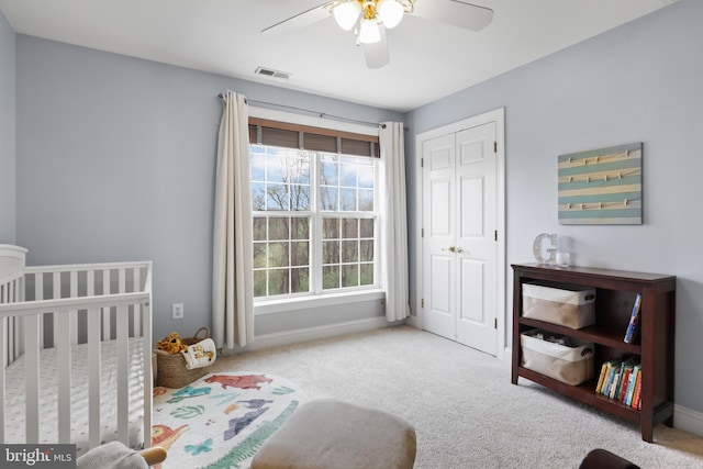 bedroom with carpet, a closet, baseboards, and ceiling fan