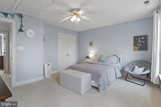 bedroom featuring attic access, light carpet, a closet, ceiling fan, and baseboards