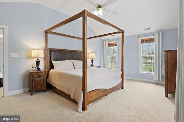 bedroom with vaulted ceiling, light carpet, baseboards, and ceiling fan