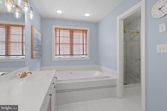 full bath featuring vanity, a marble finish shower, a garden tub, and tile patterned floors