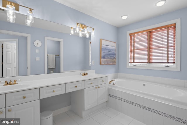 bathroom featuring a bath, tile patterned floors, and vanity