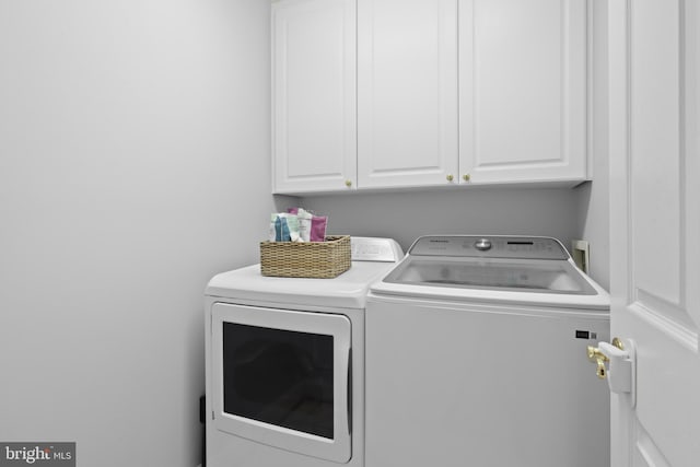 laundry area with washing machine and dryer and cabinet space