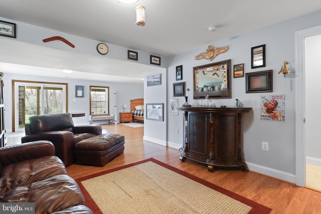 living area with wood finished floors and baseboards