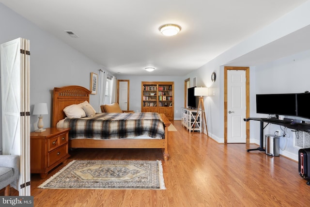 bedroom with wood finished floors and baseboards