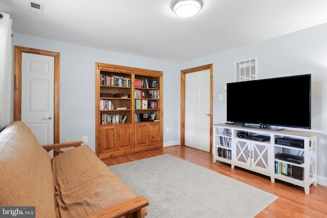 living room with light wood-style flooring and baseboards
