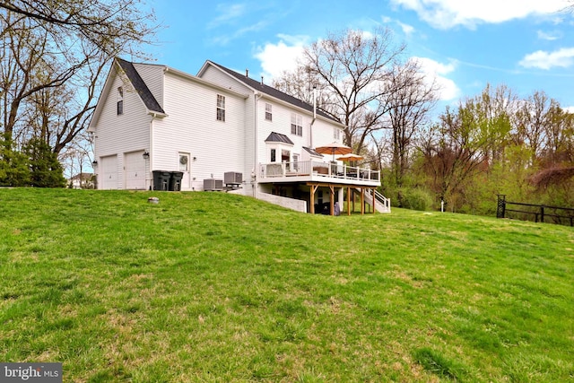 rear view of house featuring a deck, stairs, an attached garage, and central air condition unit