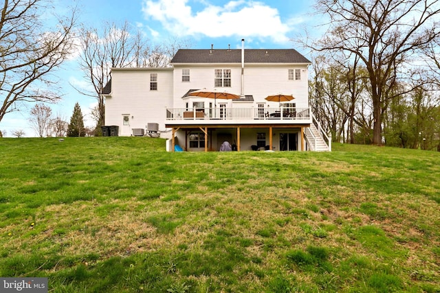 back of house featuring stairway, a deck, a lawn, and central AC unit