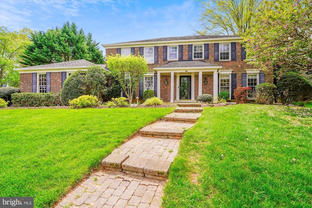 9000 Hunting Horn Ln, Potomac, MD 20854 - colonial-style house featuring brick siding and a front lawn