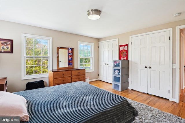 9000 Hunting Horn Ln, Potomac, MD 20854 - bedroom featuring two closets, light wood finished floors, and baseboards