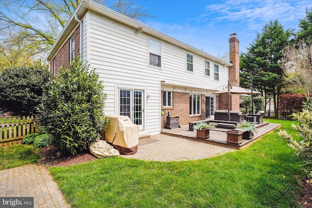 9000 Hunting Horn Ln, Potomac, MD 20854 - back of house with an outdoor living space, a chimney, brick siding, and a deck