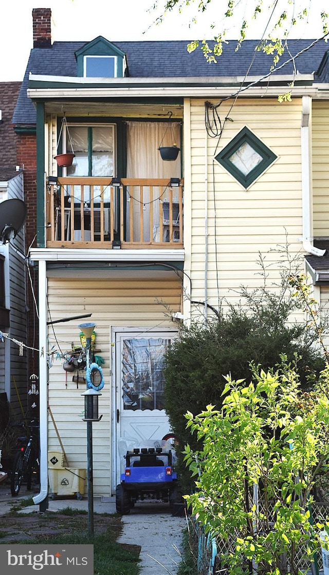 140 Baltimore St, Hanover, PA 17331 - back of property featuring roof with shingles, a balcony, and a chimney