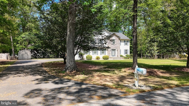 419 Kimberly Way, Felton, DE 19943 - view of front of home with asphalt driveway, a front lawn, and stone siding