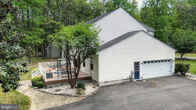 419 Kimberly Way, Felton, DE 19943 - view of property exterior featuring crawl space, asphalt driveway, a deck, and a garage