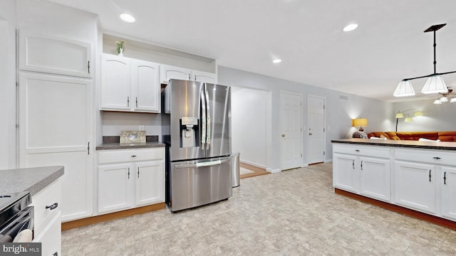 419 Kimberly Way, Felton, DE 19943 - kitchen featuring stainless steel refrigerator with ice dispenser, dark countertops, white cabinets, range with electric cooktop, and hanging light fixtures