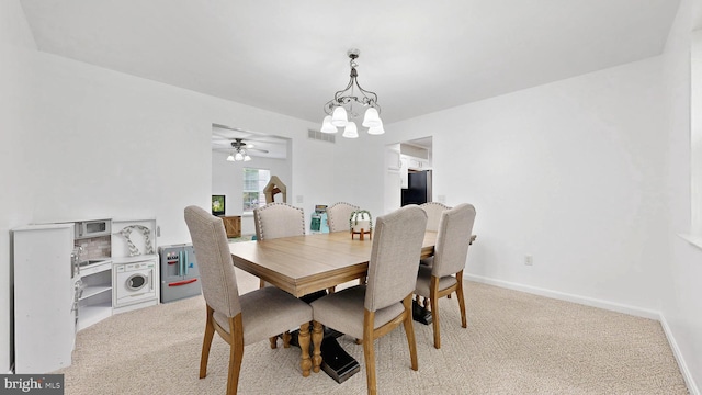 419 Kimberly Way, Felton, DE 19943 - dining area featuring a chandelier, light colored carpet, a ceiling fan, and baseboards