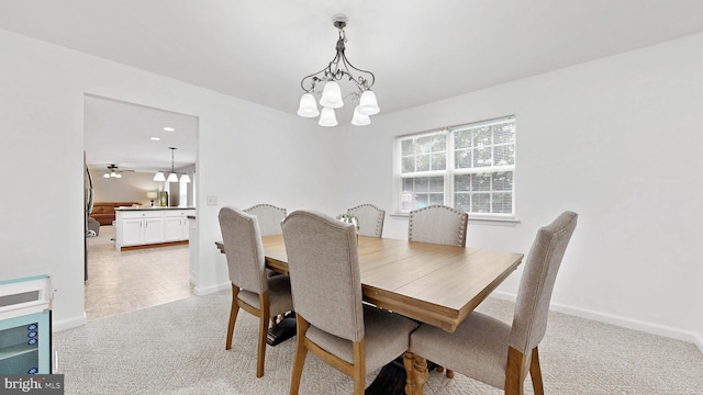 419 Kimberly Way, Felton, DE 19943 - dining space featuring light carpet, baseboards, and a chandelier