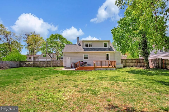 1012 Twin Vw, Glen Burnie, MD 21060 - back of property featuring a fenced backyard, a wooden deck, a chimney, and a lawn