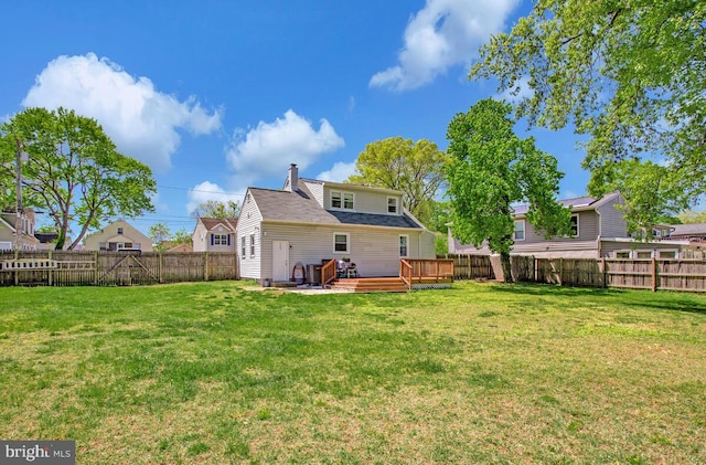 1012 Twin Vw, Glen Burnie, MD 21060 - back of house with a yard, a deck, a chimney, and a fenced backyard