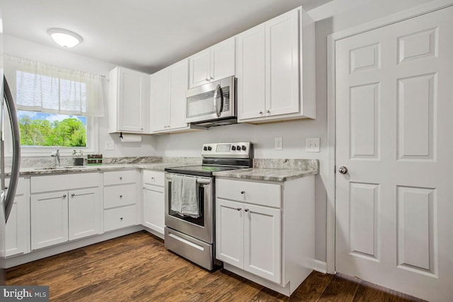 1012 Twin Vw, Glen Burnie, MD 21060 - kitchen featuring white cabinets, light stone countertops, appliances with stainless steel finishes, and a sink