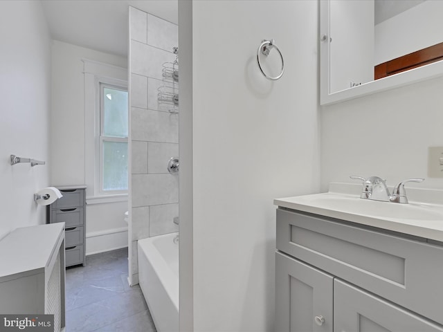 bathroom featuring tile patterned floors, vanity, and shower / washtub combination
