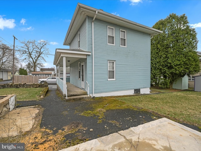 exterior space with a yard, covered porch, and fence