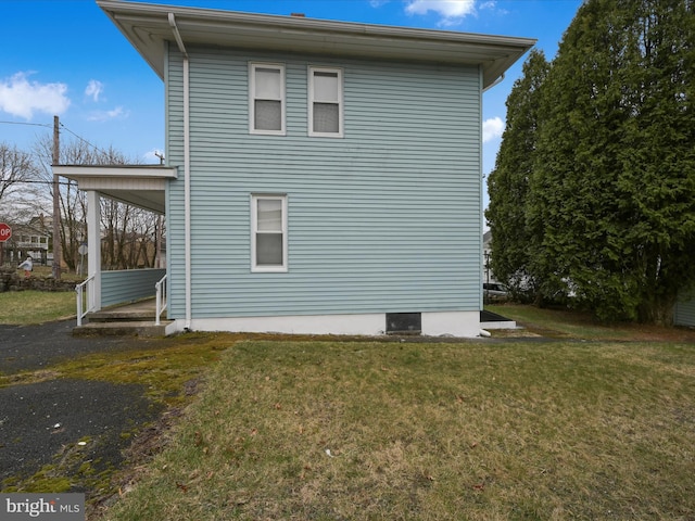 view of home's exterior with a yard